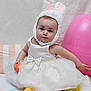 Katherine joined the competition — help win amazing prizes! baby, child, bunny_ears, white_dress, pearls, easter_eggs, pink_balloon, toy, cute, sitting, indoor, soft_lighting, face, headwear, celebration, holiday, pastel_colors, playful, infant, portrait