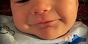 Bradley joined the competition — help win amazing prizes! baby, infant, face, smile, clothing, onesie, dinosaur, text, close_up, cute, child, young, portrait, skin, head, happy, sleepy, baby_garment, soft, indoors