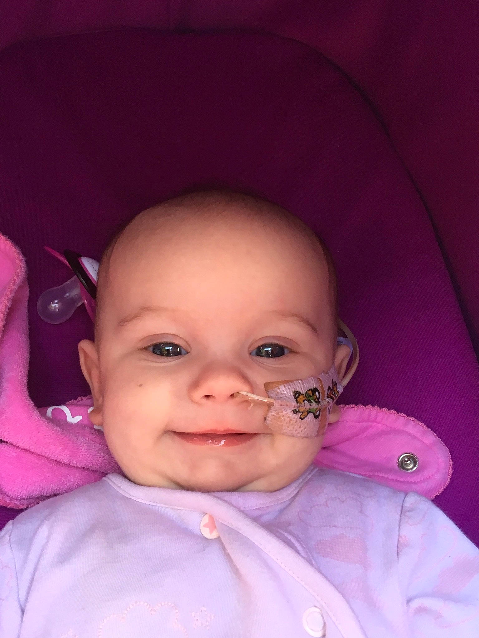 Ellie-mae is registered to the contest to win money with this photo: baby, beauty, cheek, child, chin, eye, eyebrow, face, facial_expression, forehead, head, iris, lip, mouth, nose, person, pink, purple, skin, smile
