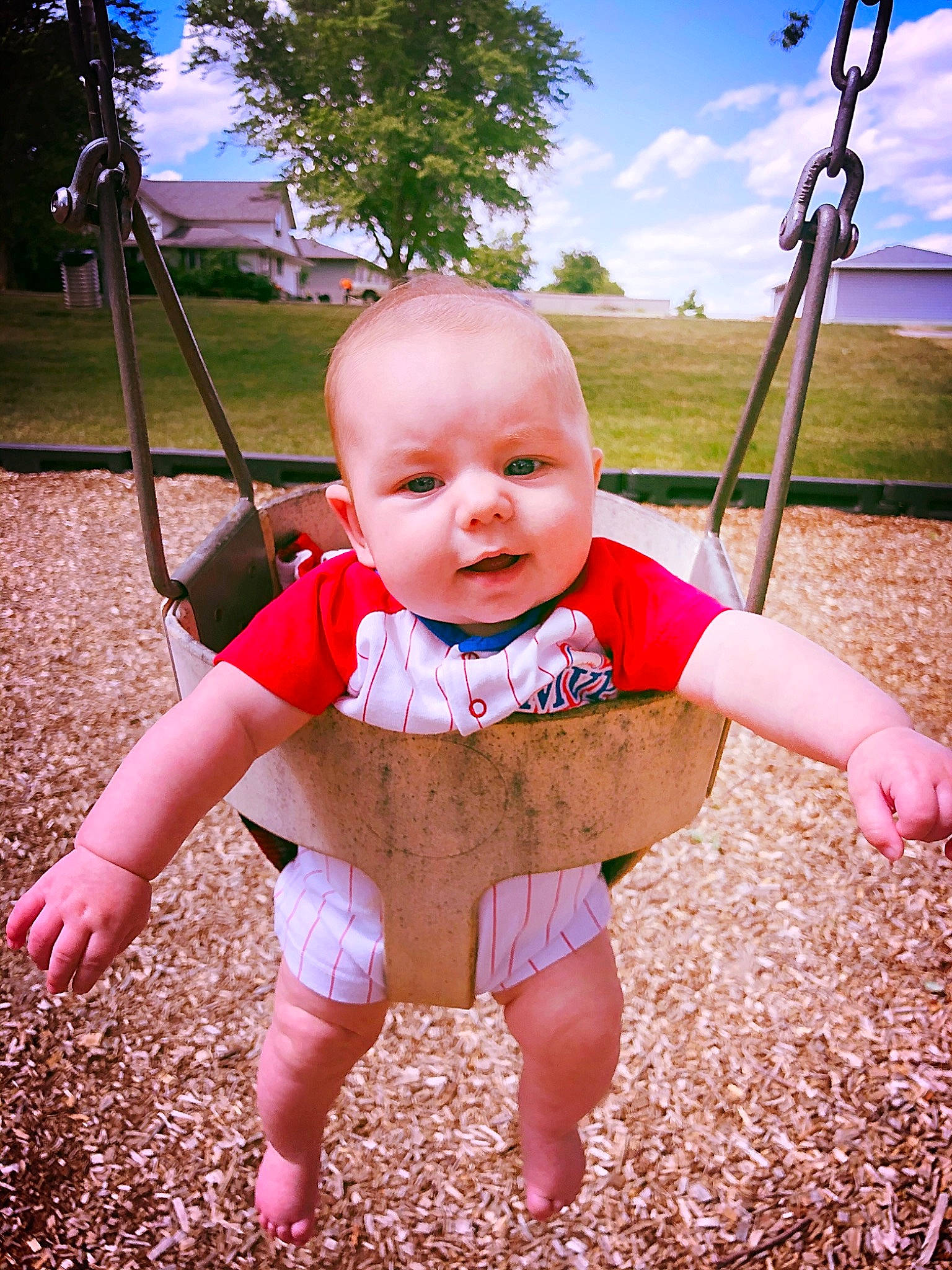 James Wayne is registered to the contest to win money with this photo: arm, baby_toddler_clothing, cloud, eye, finger, flash_photography, fun, grass, hairstyle, hand, happy, leaf, people_in_nature, person, pink, plant, skin, sky, sunlight, swing