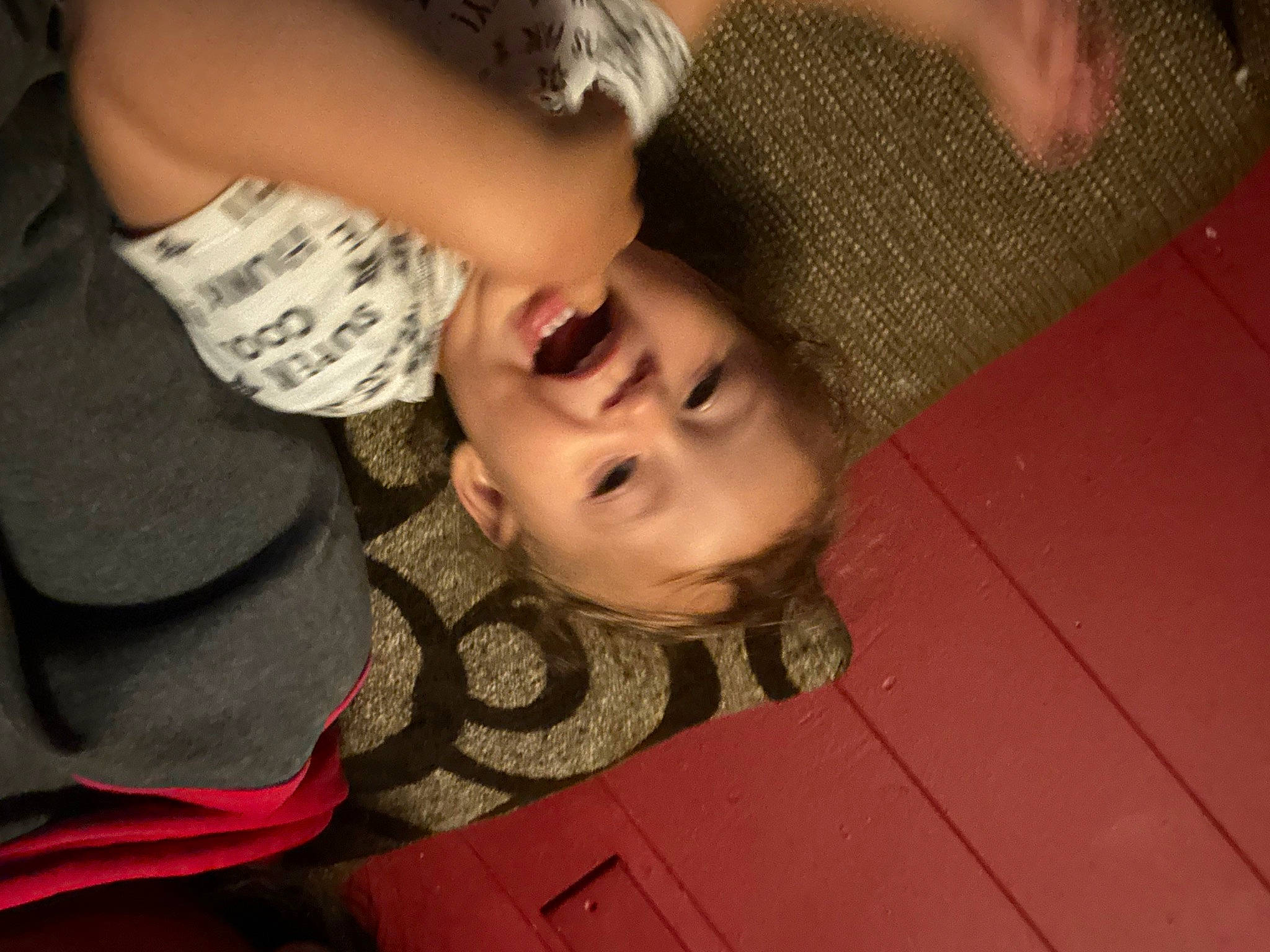 Gianni is registered to the contest to win money with this photo: black_hair, chest, child, elbow, finger, flooring, fun, gesture, grass, happy, hardwood, human_leg, mouth, neck, nose, pattern, person, smile, thigh, toddler