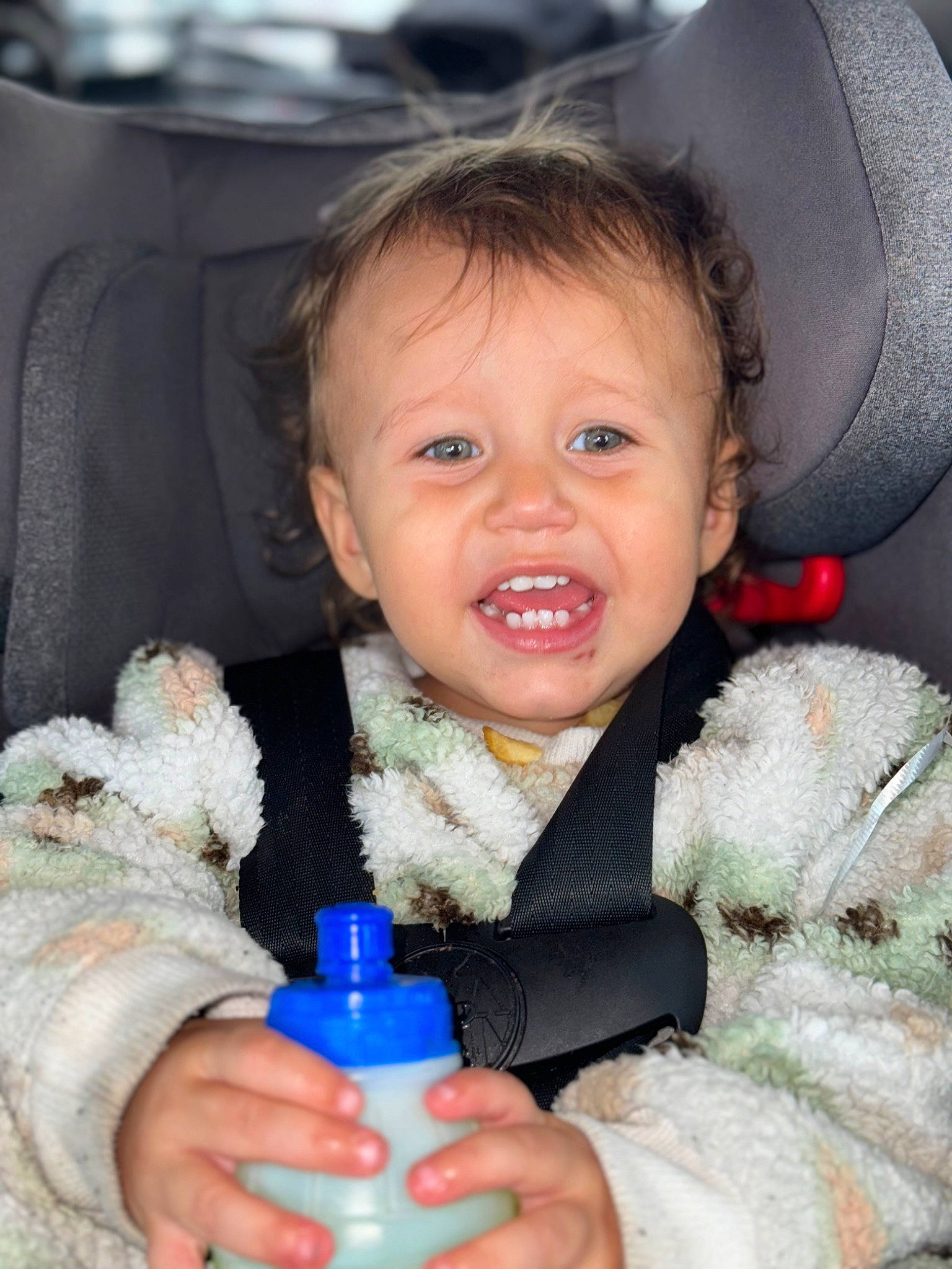 Gianni is registered to the contest to win money with this photo: baby, baby_products, baby_toddler_clothing, bottle, car_seat, cheek, child, comfort, drinkware, electric_blue, finger, fun, happy, person, plastic_bottle, product, skin, smile, stuffed_toy, toddler