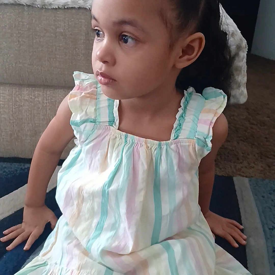 Traylynn joined the competition — help win amazing prizes! carpet, casual_clothing, child, curly_hair, cute, dress, fashion, floor, girl, hair_buns, home_interior, indoors, looking_away, pastel_colors, person, portrait, sitting, thoughtful, young_child, young_female