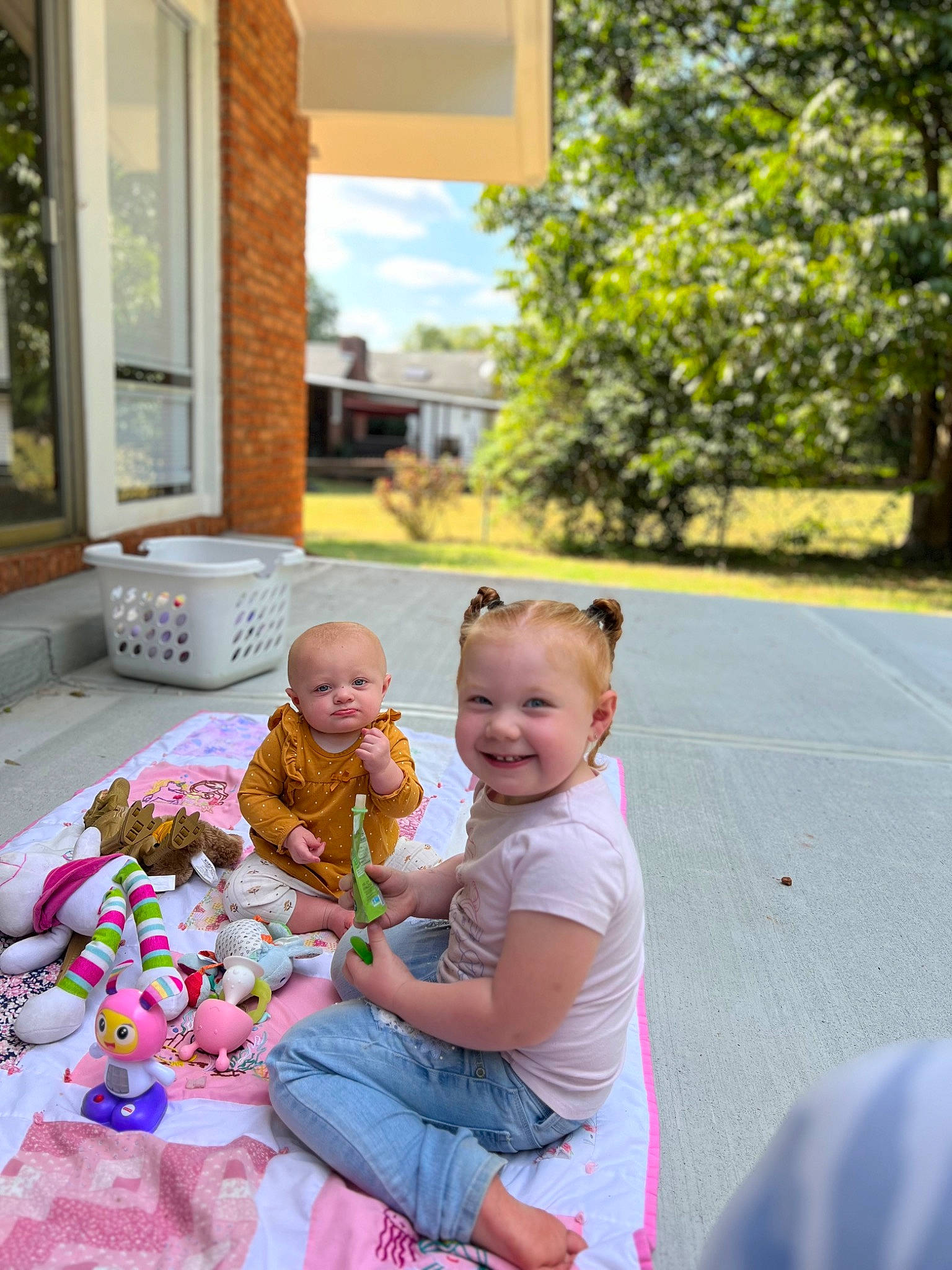 Addilynn is registered to the contest to win money with this photo: baby, door, event, fun, grass, happy, joy, leisure, person, pink, plant, recreation, sitting, smile, snapshot, summer, t_shirt, toddler, toy, tree