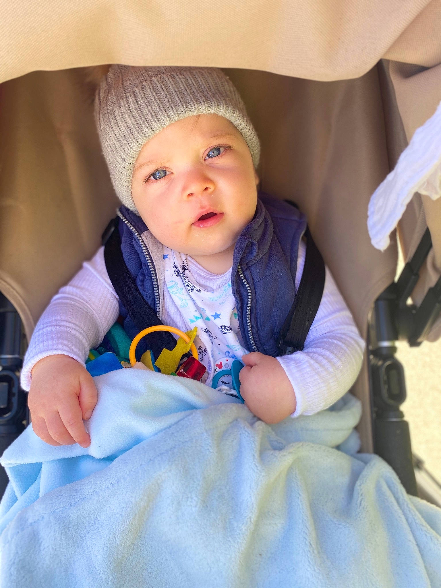 Jai is registered to the contest to win money with this photo: baby, baby_carriage, baby_products, cheek, child, eye, face, head, headwear, infant_bed, linens, people, person, product, sitting, skin, smile, toddler, vacation