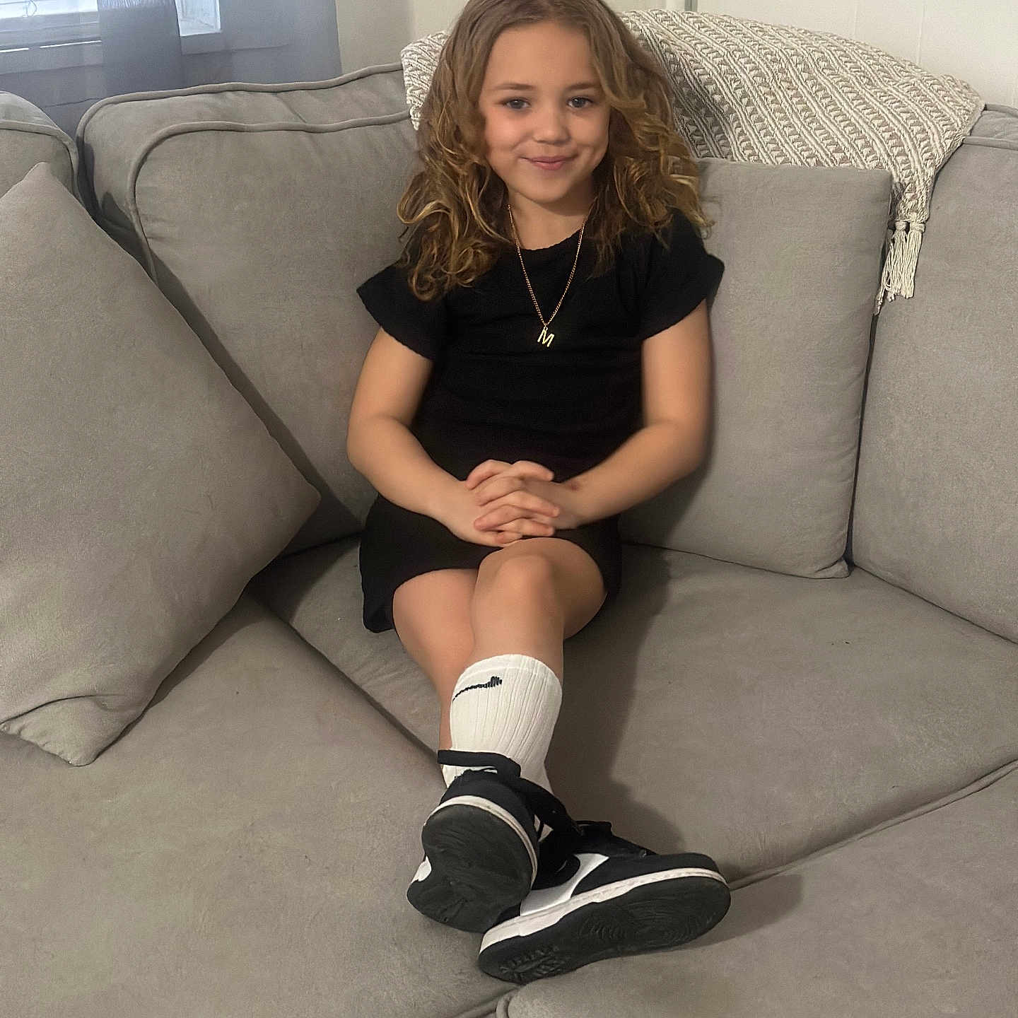 Madison is registered to the contest to win money with this photo: accessories, bodypart, clothing, couch, face, female, footwear, furniture, girl, head, jewelry, necklace, person, photography, portrait, shoe, shorts, sitting, sneaker, teen