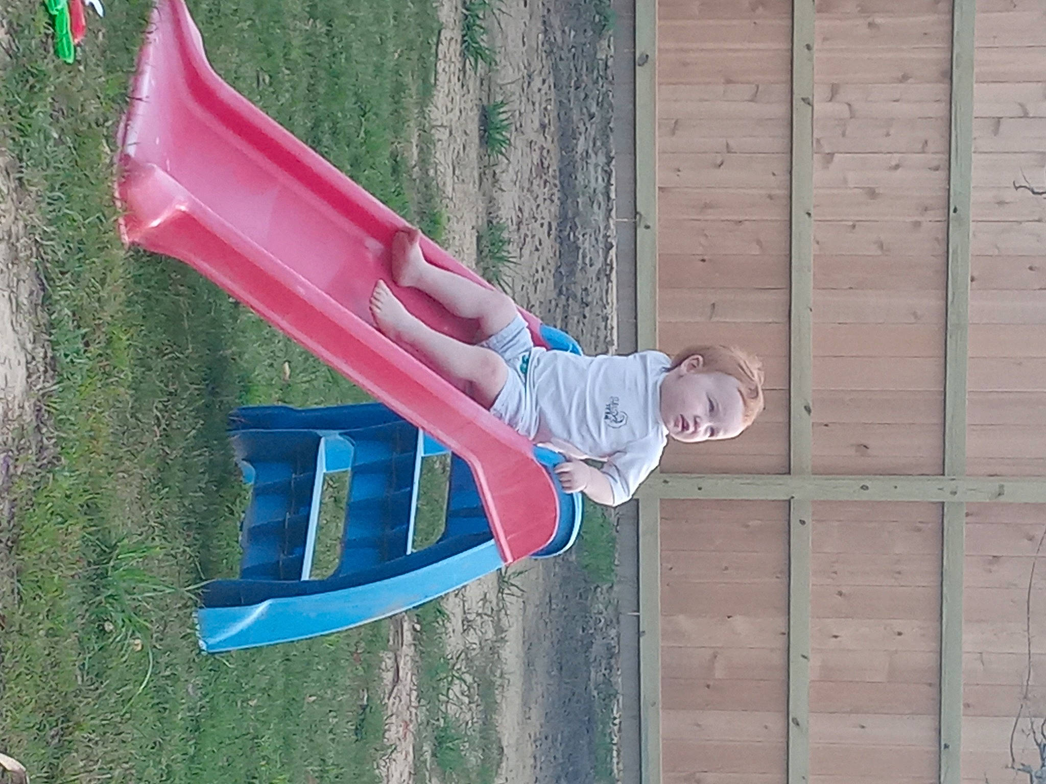 Layton is registered to the contest to win money with this photo: carmine, elbow, electric_blue, facade, fun, grass, leisure, magenta, paint, person, plank, rectangle, siding, sleeve, street_fashion, t_shirt, wood, wood_stain