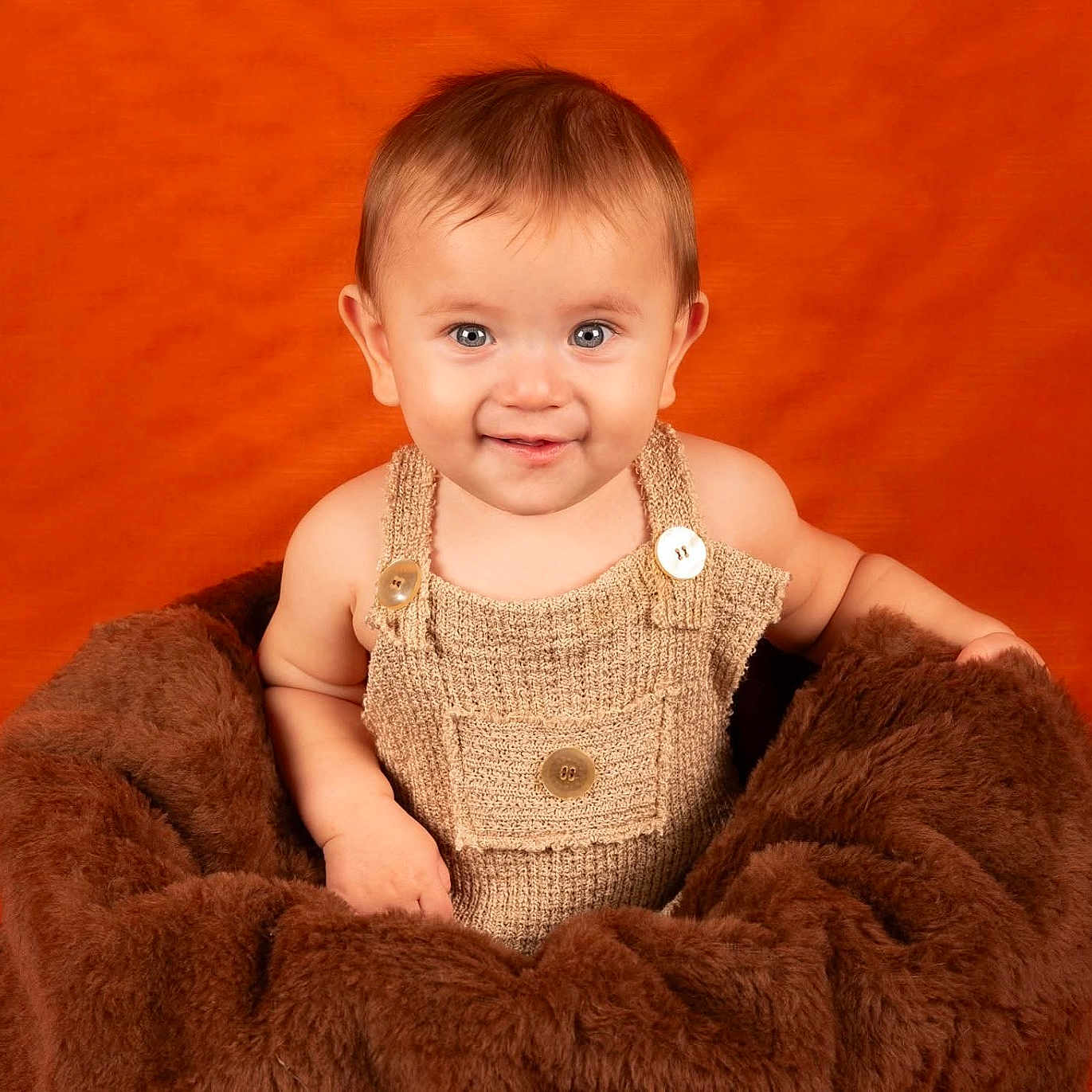 Chipper is registered to the contest to win money with this photo: accessories, baby, babylaughing, blanket, bodypart, clothing, face, finger, happy, head, jewelry, knitwear, necklace, pants, person, photography, portrait, sitting, smile, sweater