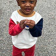 Kashton joined the competition — help win amazing prizes! toddler, child, curly_hair, pigtails, sweatshirt, red_pants, boots, outdoor, gravel, standing, looking_up, hands_together, casual_clothing, cute, young_child, curious_expression, colorful_clothes, portrait, person, daylight