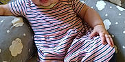 Layla is registered to the contest to win money with this photo: baby, bow, child, chubby_cheeks, cloud_pattern, comfort, cushion, cute, floor, headband, home, indoor, infant, leggings, person, sitting, striped_dress, tongue_out, toy, wooden_floor