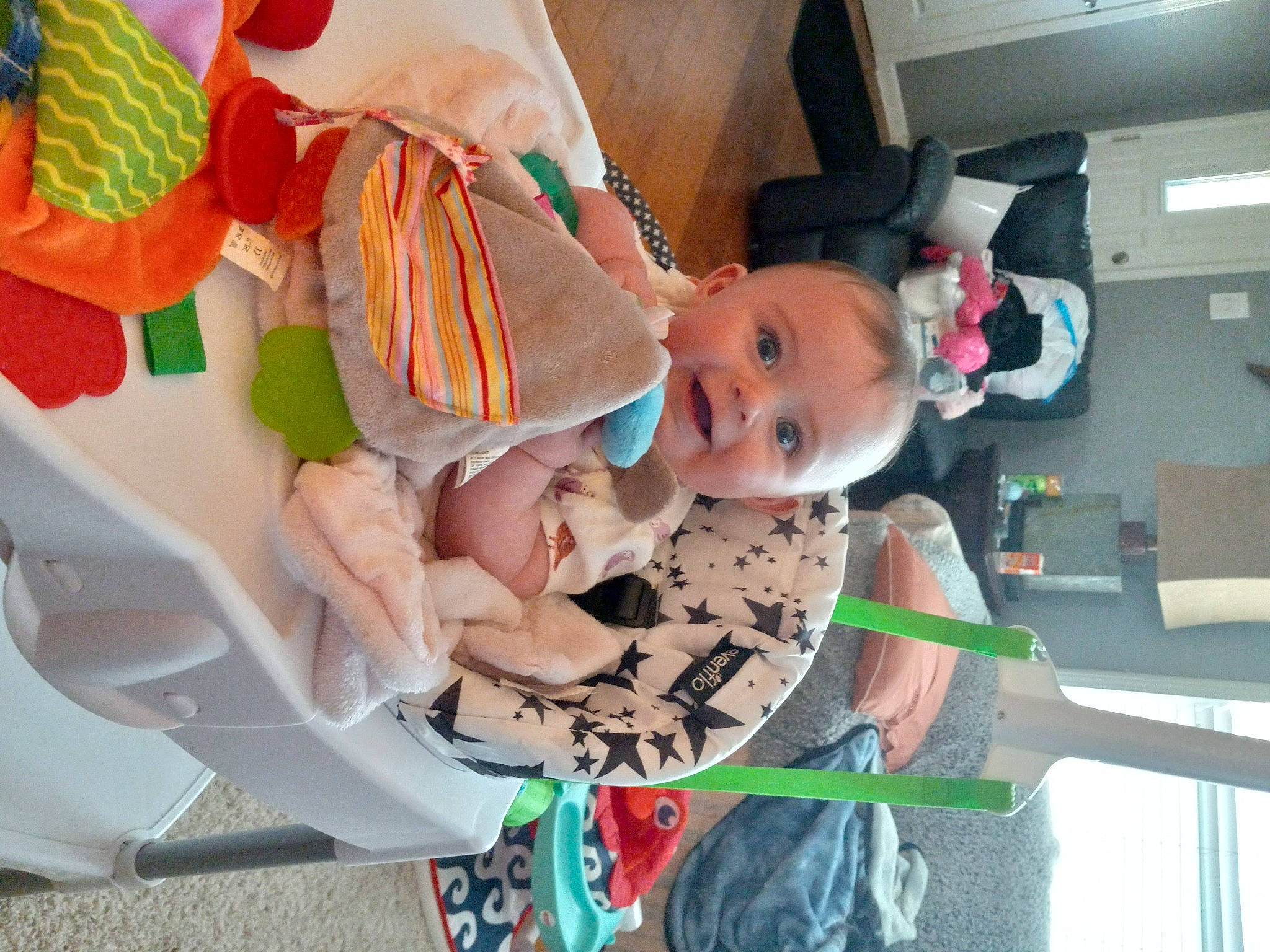 Madeline is registered to the contest to win money with this photo: baby, baby_carriage, baby_products, baby_safety, baby_toddler_clothing, baby_toys, child, comfort, peach, person, room, smile, toddler