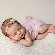 Charlee is registered to the contest to win money with this photo: newborn, baby, sleeping, infant, pink_wrap, floral_headband, soft_blanket, peaceful, cute, portrait, skin, head, legs, hands, closed_eyes, rest, cozy, tender, child, wrapped