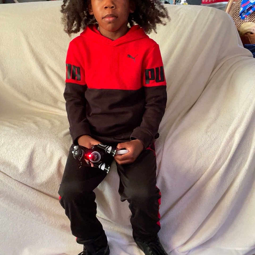 Kahdeem is registered to the contest to win money with this photo: boy, child, clothing, costume, couch, cushion, face, footwear, furniture, glove, head, homedecor, male, pants, person, photoframe, photography, portrait, shoe, sitting