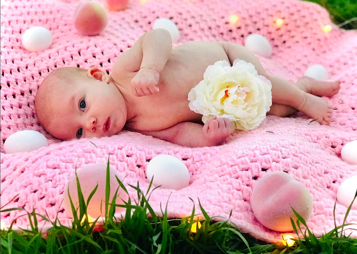 Camilla joined the competition — help win amazing prizes! baby, baby_products, baby_sleeping, baby_toddler_clothing, bedtime, child, comfort, flower, grass, happy, linens, pattern, people_in_nature, person, petal, pink, sitting, spring, sweetness, textile