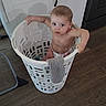Asher joined the competition — help win amazing prizes! baby, child, infant, laundry_basket, diaper, indoors, sitting, portrait, face, eyes, brown_hair, curious, laundry, sock, clothing, floor, cabinet, home, playful, photography