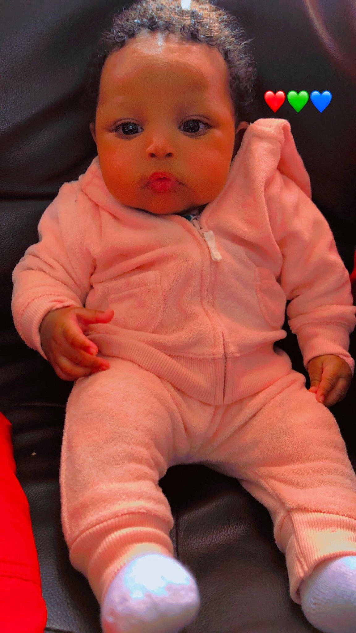 Jaliyah is registered to the contest to win money with this photo: baby_toddler_clothing, cheek, chin, comfort, eye, eyebrow, face, facial_expression, finger, head, lip, mouth, neck, nose, orange, person, pink, skin, sleeve, textile