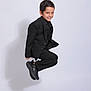 Rayan joined the competition — help win amazing prizes! child, boy, jumping, black_suit, smiling, studio, portrait, white_background, shadow, short_hair, happy, fashion, posing, footwear, casual, young, energetic, playful, clothing, single_person