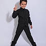 Rayan joined the competition — help win amazing prizes! child, boy, black_clothing, vest, dress_pants, sneakers, peace_sign, pose, studio, portrait, confident, smile, short_hair, standing, full_body, shadow, fashion, young, isolated, background
