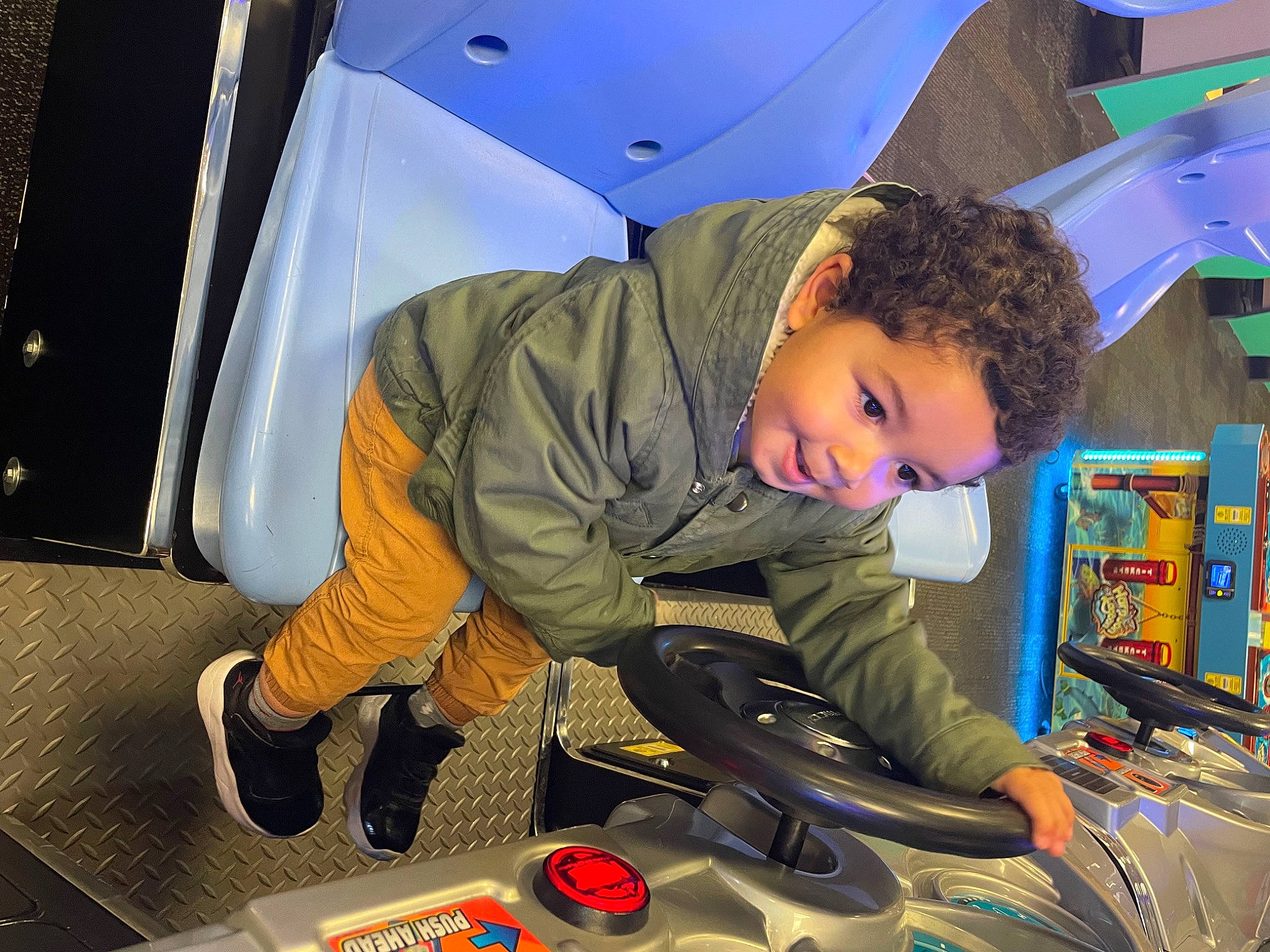 Christopher is registered to the contest to win money with this photo: aerospace_engineering, audio_equipment, automotive_design, automotive_exterior, child, flash_photography, fun, gadget, leisure, luxury_vehicle, machine, motor_vehicle, person, play, recreation, room, sitting, space, toddler, vehicle_door