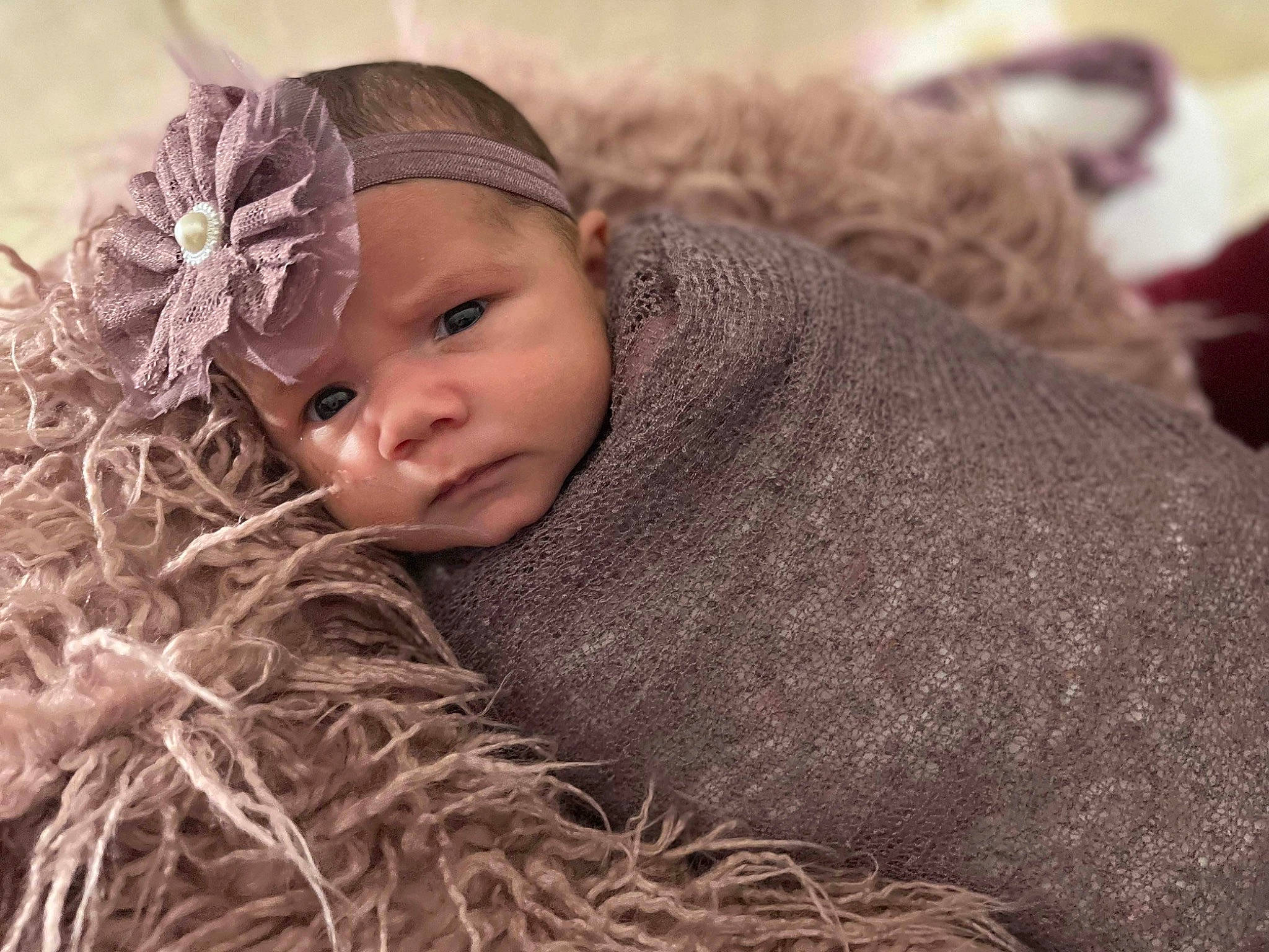 Miley joined the competition — help win amazing prizes! baby, beanie, brown_hair, cap, child, comfort, fur, grass, happy, hat, hay, knit_cap, landscape, linens, people_in_nature, person, portrait_photography, toddler, wood, wool