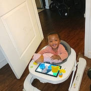 Summer joined the competition — help win amazing prizes! baby, walker, doll, tablet, smile, indoor, wooden_floor, stroller, child, toy, person_reflection, happy, clothing, door, floor, seat, playtime, infant, home, furniture
