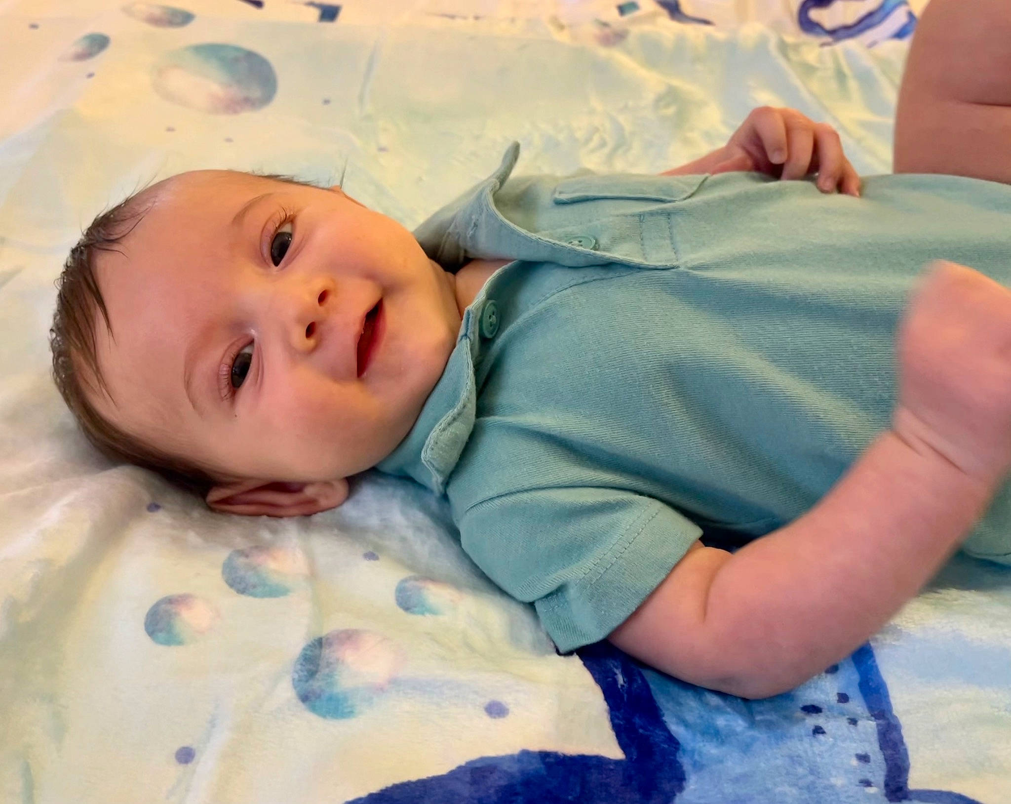 Luke is registered to the contest to win money with this photo: azure, baby, baby_toddler_clothing, beauty, bedding, bedtime, cheek, child, comfort, happy, head, linens, nose, pattern, person, room, skin, sleeve, smile, textile