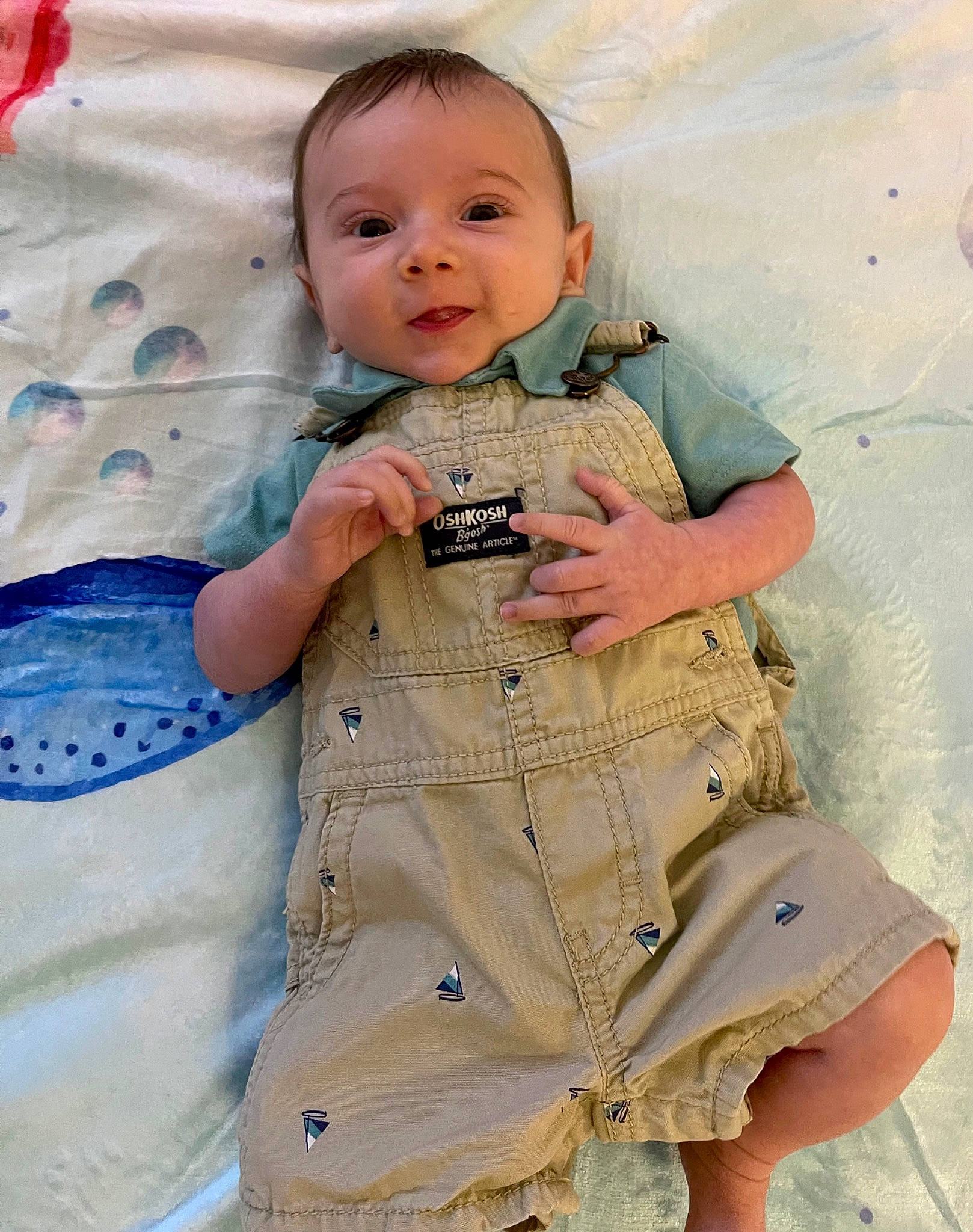 Luke is registered to the contest to win money with this photo: arm, baby, baby_products, baby_toddler_clothing, child, denim, finger, happy, joint, outerwear, pattern, person, pink, skin, sleeve, smile, standing, t_shirt, textile, toddler