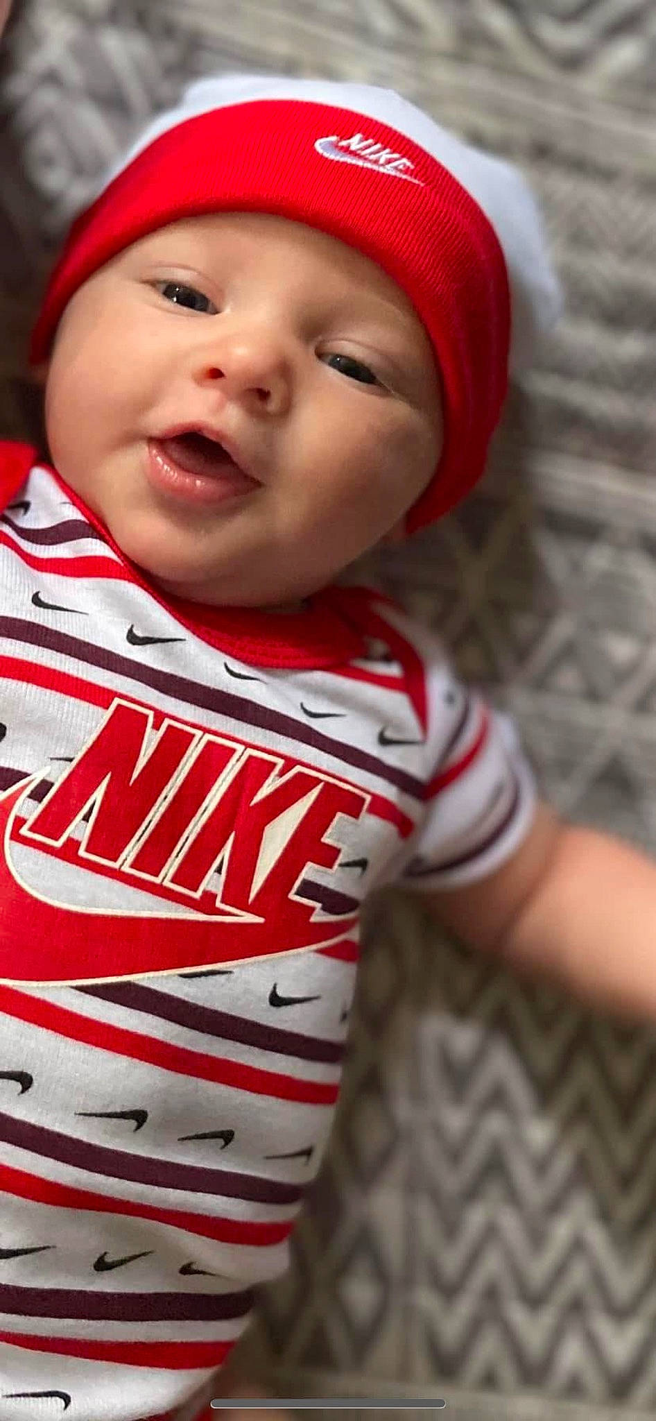 Kohen is registered to the contest to win money with this photo: baby, cap, cheek, chin, eye, eyebrow, face, facial_expression, happy, head, headwear, jersey, lip, mouth, nose, outerwear, person, skin, sleeve, smile