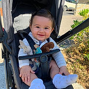 Marceau a rejoint le concours — aidez-le/la à gagner de superbes lots ! baby, baby_toys, casual, child, clothing, cute, greenery, happy, infant, nature, outdoor, parked_car, person, seat, smiling, sock, stroller, sunlight, toy, transport
