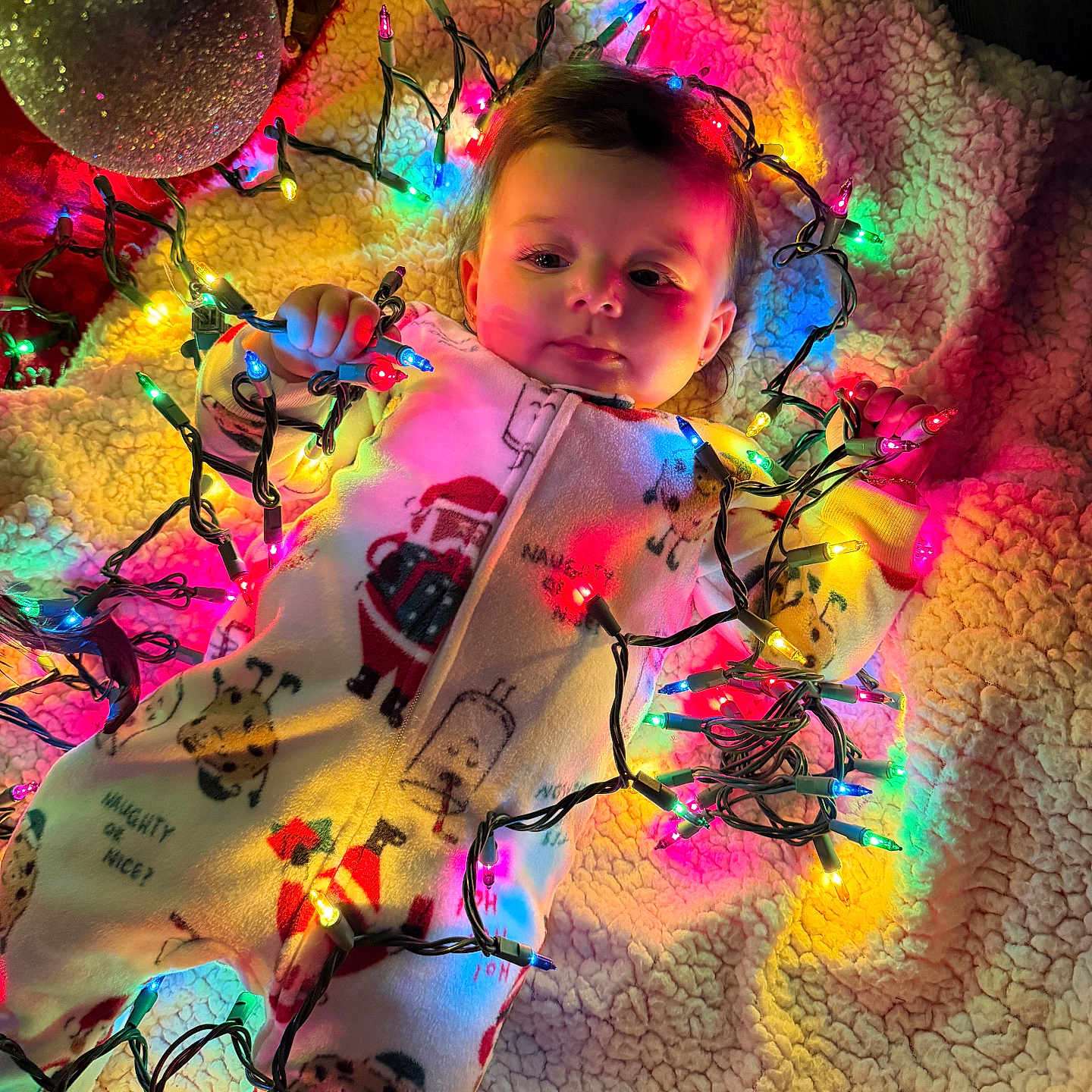 Rosarita joined the competition — help win amazing prizes! baby, blanket, child, christmas, christmas_lights, colorful_lights, cozy, cute, face, festive, hand, holiday, holiday_decor, indoor, ornament, pajamas, smiling, soft_texture, toddler, warm