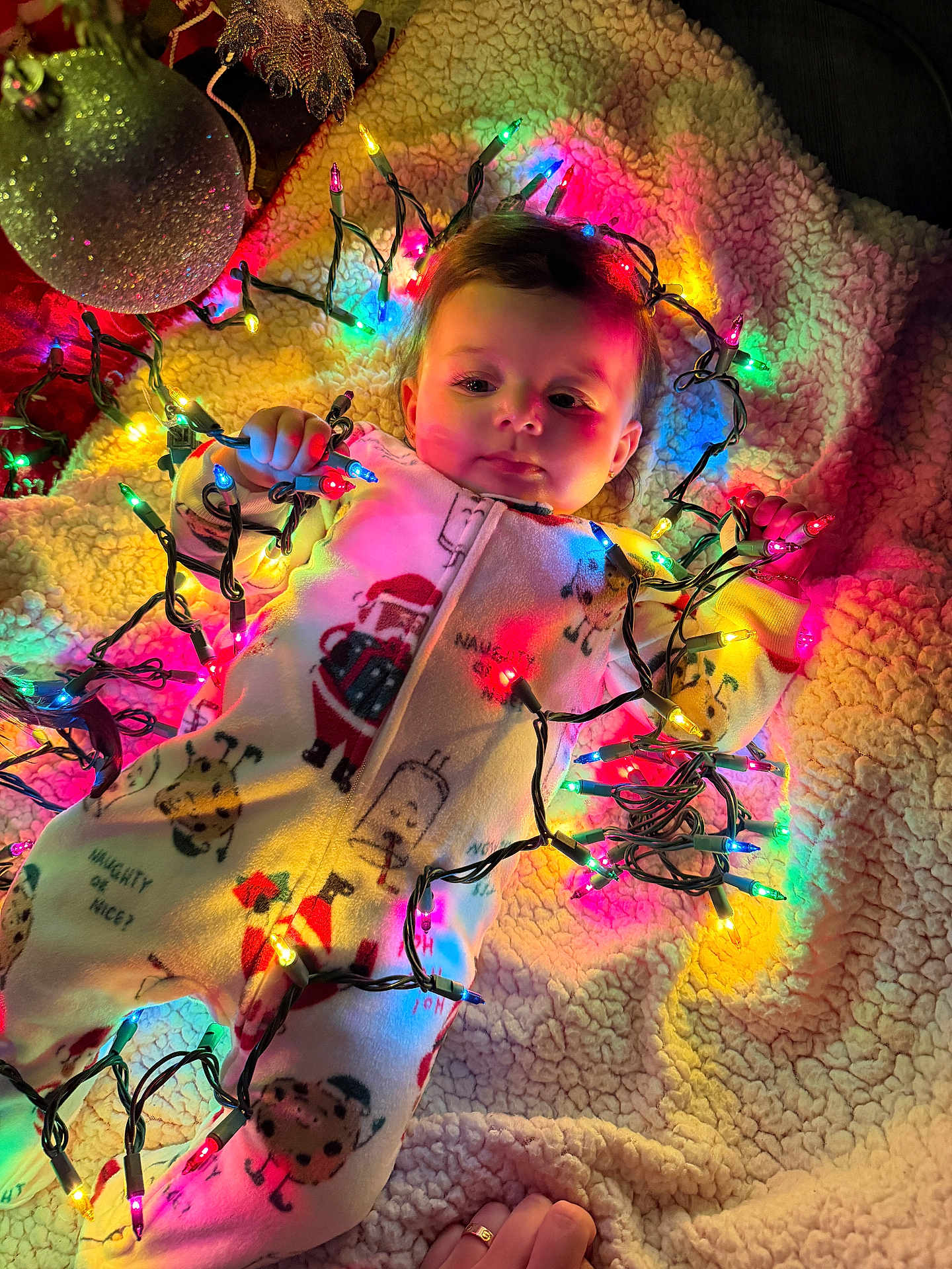 Rosarita joined the competition — help win amazing prizes! baby, blanket, child, christmas, christmas_lights, colorful_lights, cozy, cute, face, festive, hand, holiday, holiday_decor, indoor, ornament, pajamas, smiling, soft_texture, toddler, warm