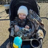 Cohen joined the competition — help win amazing prizes! baby, child, stroller, smiling, outdoor, winter, hat, blanket, sippy_cup, infant, portrait, sitting, bundled_up, sunlight, pavement, walkway, carseat, clothing, happy, family_outing