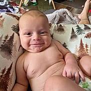 Leon joined the competition — help win amazing prizes! baby, smiling, infant, naked, pillow, pattern, forest, blanket, toy, home, indoor, relaxed, cute, child, diaper, skin, person, comfort, lying, happy