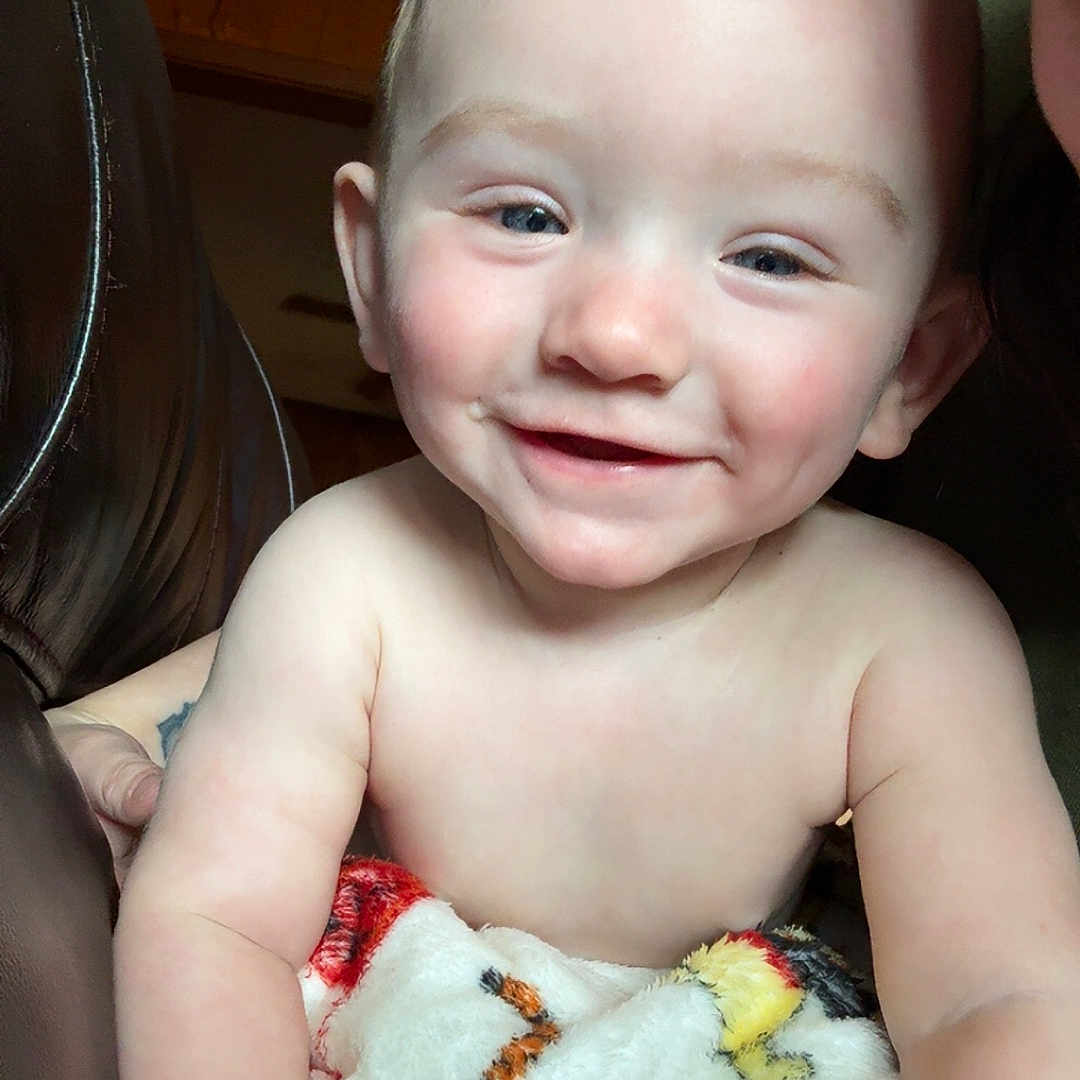 Malcolm joined the competition — help win amazing prizes! arm, baby, blanket, child, comfort, cozy, cute, expression, face, hand, happy, indoor, infant, person, portrait, skin, smiling, tiger_pattern, warm, young