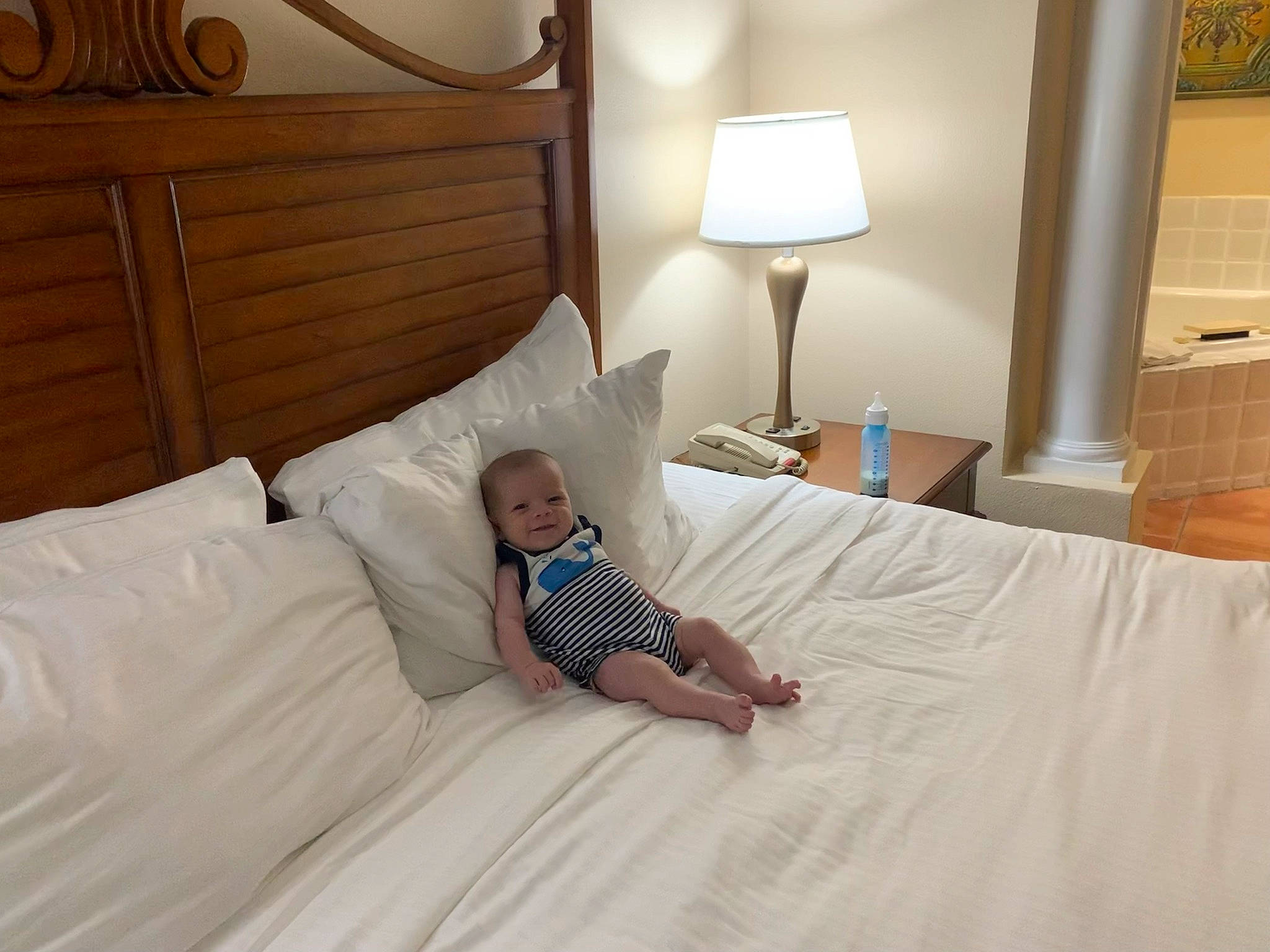 Evan is registered to the contest to win money with this photo: bed, bed_frame, bed_sheet, bedding, bedroom, comfort, floor, flooring, furniture, hardwood, head, interior_design, lamp, linens, person, pillow, property, t_shirt, textile, throw_pillow