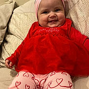 Shaddaimarie joined the competition — help win amazing prizes! baby, child, smiling, red_dress, pink_headband, bow, heart_pattern, leggings, sofa, cushion, tufted_sofa, indoor, happy, cute, portrait, person, infant, seated, clothing, cozy