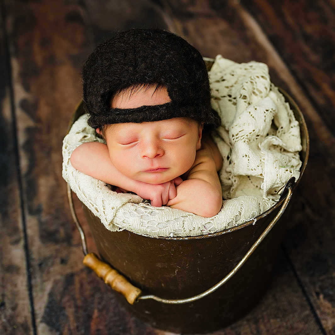 Ares joined the competition — help win amazing prizes! baby, basket, beanie, bed, bonnet, bucket, cap, clothing, face, furniture, happy, hardwood, hat, head, newborn, person, photography, portrait, sleeping, wood