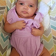 Jalyssa is registered to the contest to win money with this photo: baby, infant, romper, purple_clothing, chevron_pattern, cushion, cute, child, person, indoors, face, skin, hand, legs, expression, portrait, newborn, lying_down, fabric, soft