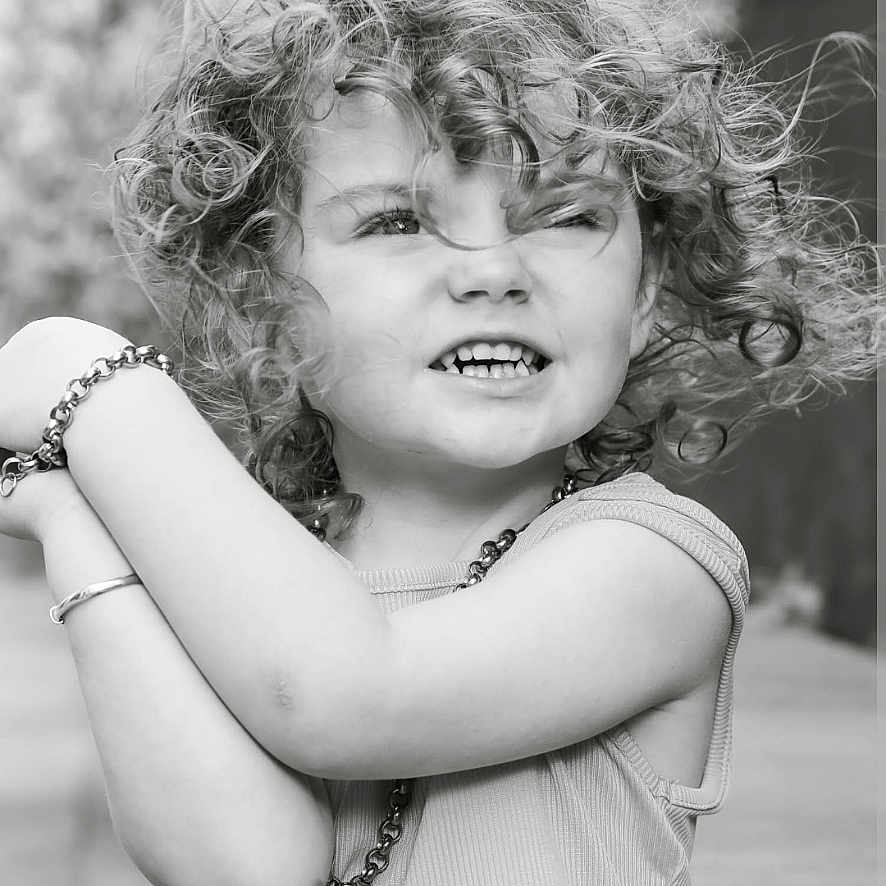Dolly-Storm joined the competition — help win amazing prizes! arms, black_and_white, bracelet, casual_clothing, child, closeup, curly_hair, cute, expression, face, happy, natural_light, necklace, outdoor, person, playful, portrait, smile, tank_top, young