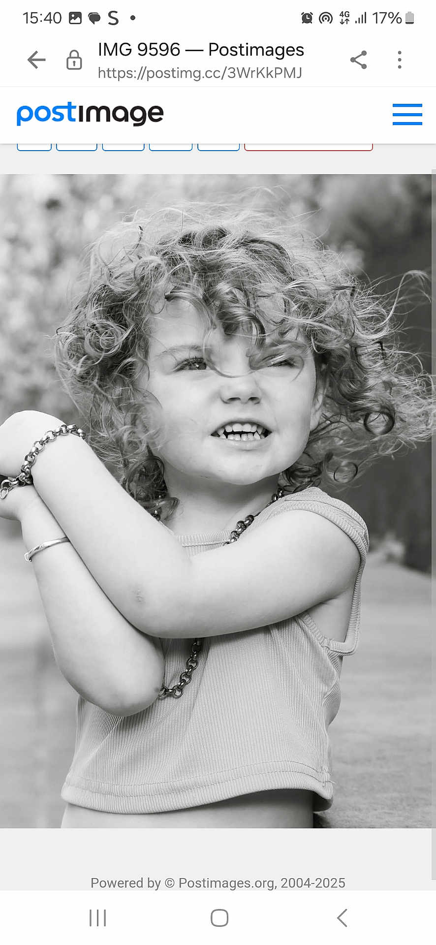 Dolly-Storm joined the competition — help win amazing prizes! child, curly_hair, black_and_white, portrait, smile, bracelet, tank_top, outdoor, expression, face, person, necklace, cute, young, arms, happy, casual_clothing, closeup, natural_light, playful