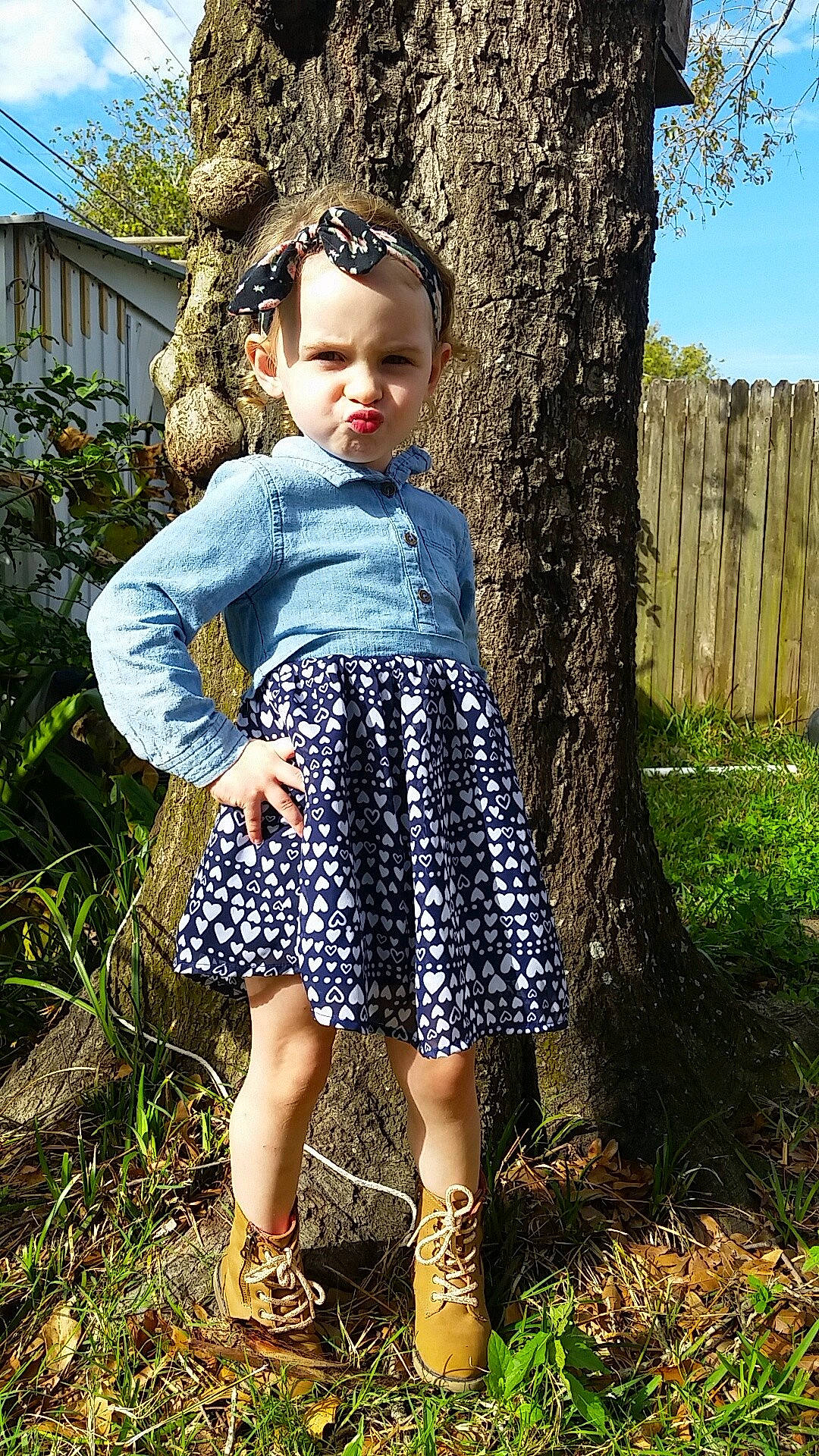 Layla is registered to the contest to win money with this photo: child, clothing, dress, garden, girl, grass, outerwear, pattern, person, plant, toddler, tree