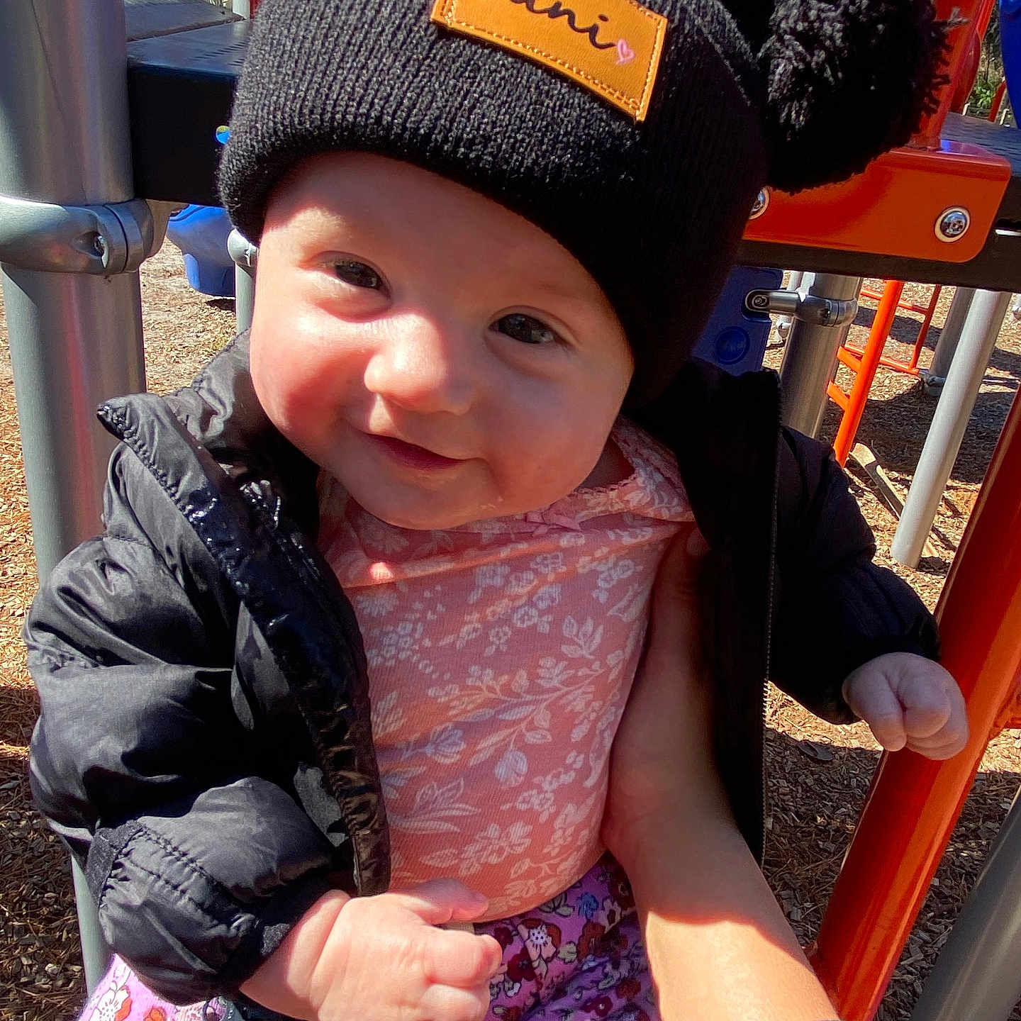 Oakley is registered to the contest to win money with this photo: baby, beanie, bodypart, bonnet, cap, clothing, coat, face, finger, hand, hat, head, jacket, outdoorplayarea, outdoors, pants, person, photography, playarea, portrait