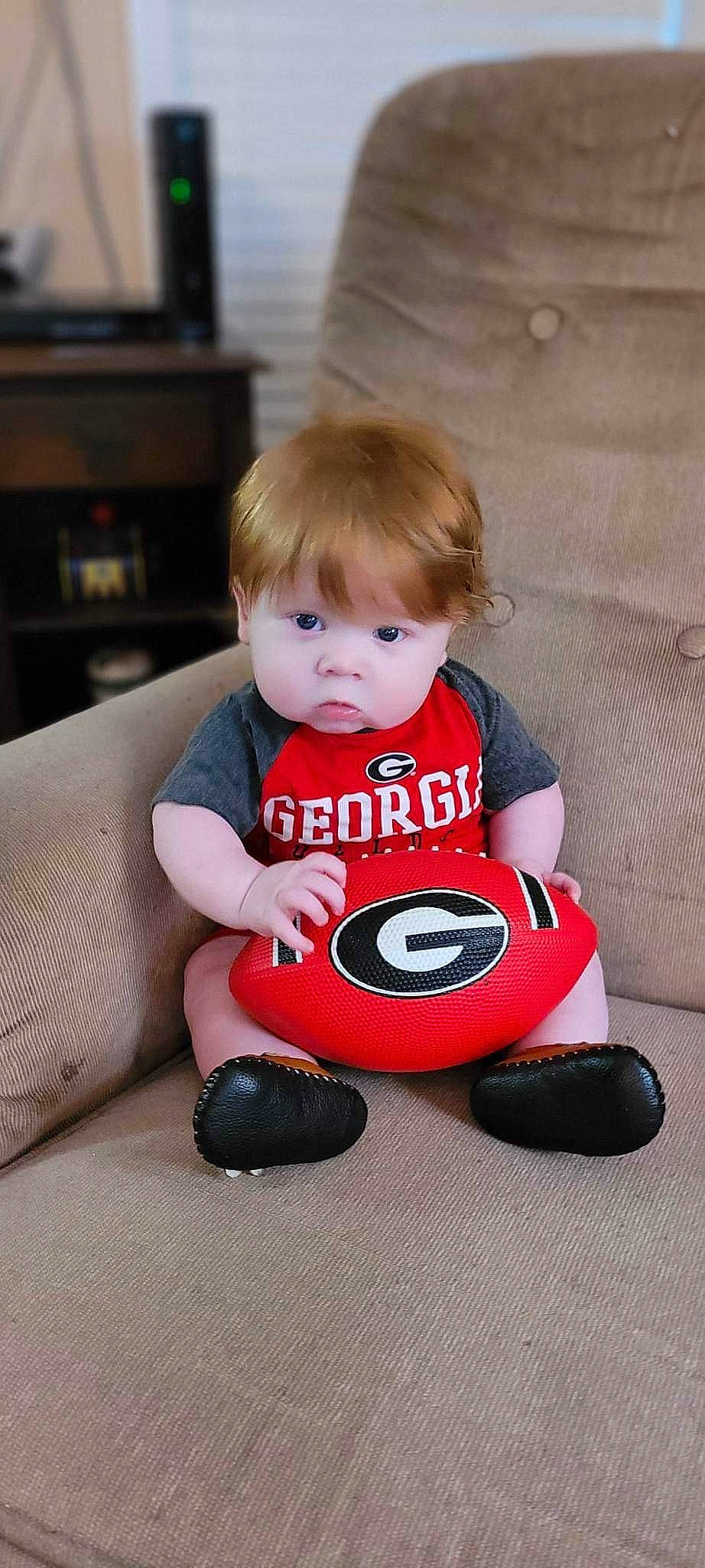 Tristen is registered to the contest to win money with this photo: automotive_tire, baby, baby_playing_with_toys, baby_products, baby_toddler_clothing, baby_toys, carmine, child, comfort, eye, flooring, fun, gadget, happy, person, room, sitting, sleeve, t_shirt, toddler