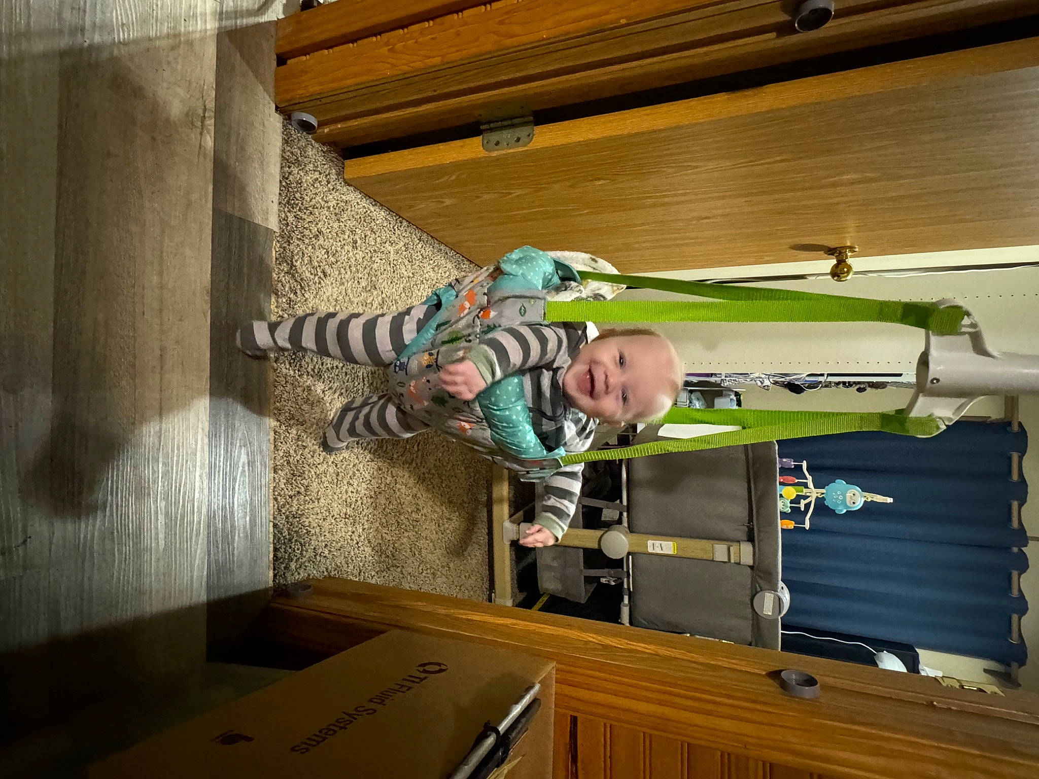 Bryson is registered to the contest to win money with this photo: building, cabinetry, ceiling, child, drawer, flooring, handrail, hardwood, house, jacket, joy, machine, person, plywood, room, stairs, t_shirt, table, toddler, wood