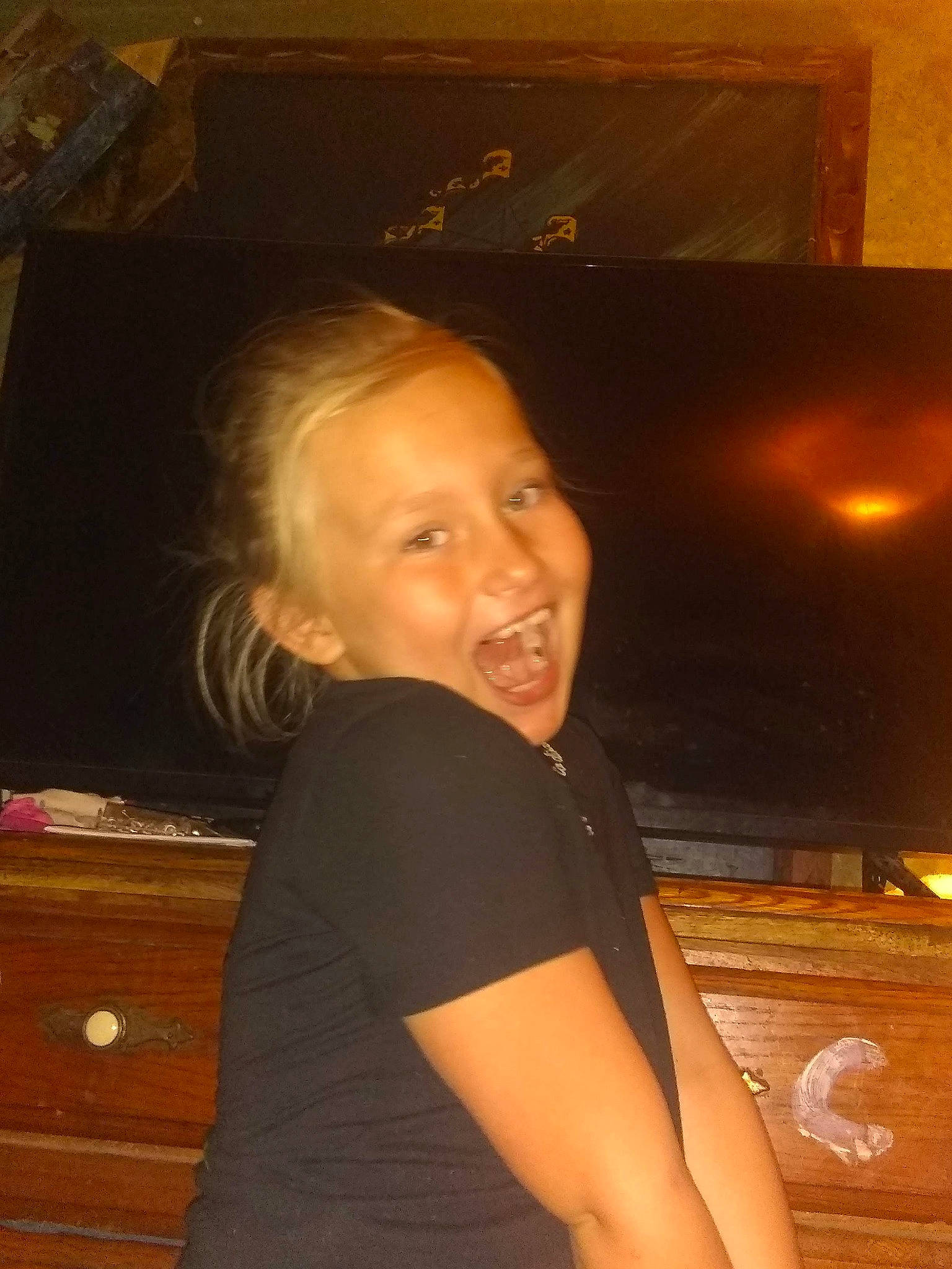 Jasmine is registered to the contest to win money with this photo: brown_hair, cheek, chest, child, chin, elbow, eyebrow, flash_photography, flooring, forehead, fun, happy, iris, long_hair, nose, person, room, space, t_shirt, thigh