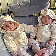 Adam And Yousef joined the competition — help win amazing prizes! baby, toddler, child, matching_outfits, hoodie, bear_ears, bear_print, pants, bare_feet, cushion, swing_chair, outdoor, porch, person, cute, infant, seated, clothing, face, expression