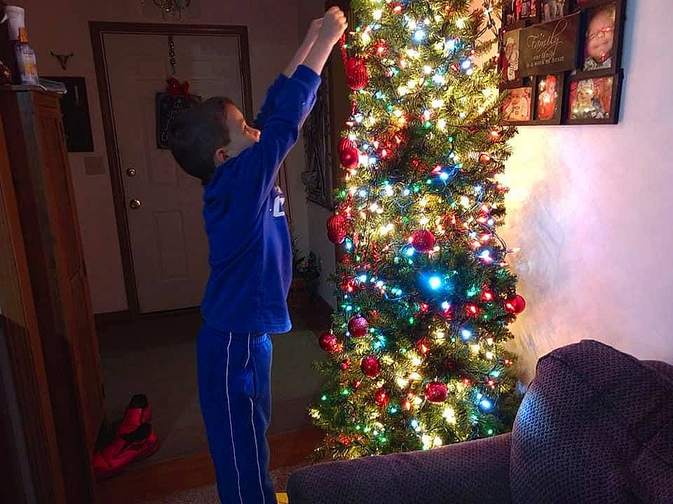 Liam is registered to the contest to win money with this photo: christmas, christmas_decoration, christmas_eve, christmas_lights, christmas_ornament, christmas_tree, conifer, decoration, event, hardwood, holiday, holiday_ornament, interior_design, ornament, person, pine_family, room, tradition, varnish, wood_stain