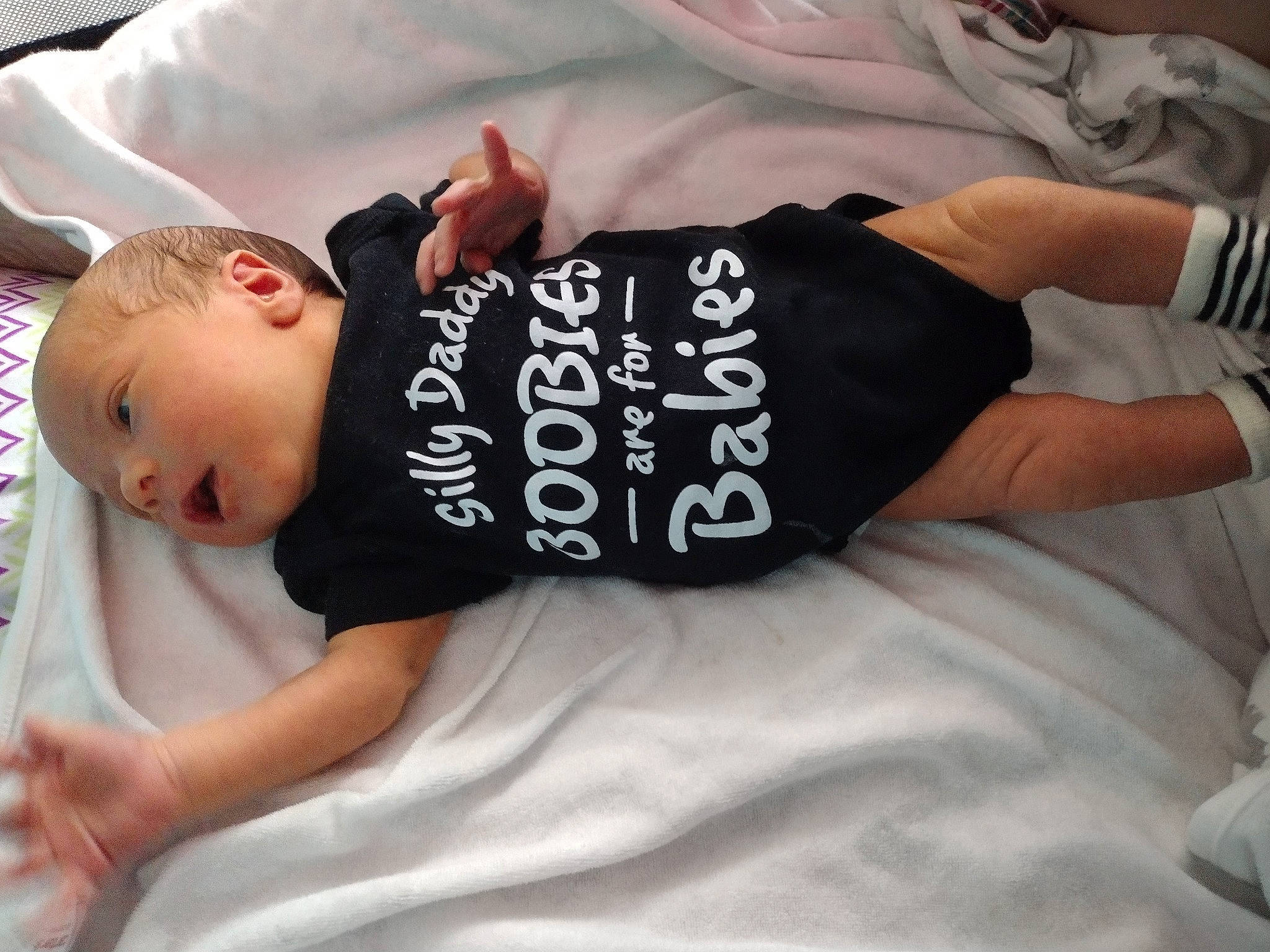 George is registered to the contest to win money with this photo: baby, baby_products, baby_safety, baby_sleeping, baby_toddler_clothing, bed, bedding, comfort, cool, elbow, font, human_body, human_leg, linens, neck, person, sleeve, t_shirt, thigh, toddler