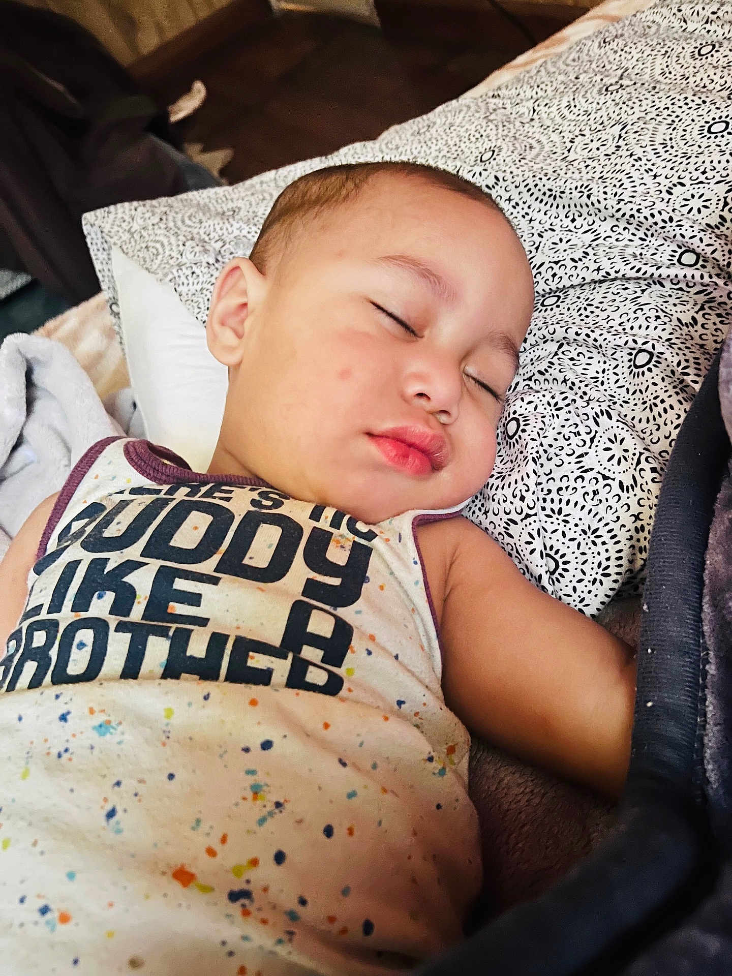 Takeshi joined the competition — help win amazing prizes! baby, sleeping, child, pillow, blanket, pattern, shirt, text, face, arm, indoor, rest, cozy, peaceful, closeup, infant, young_child, portrait, soft_lighting, comfort