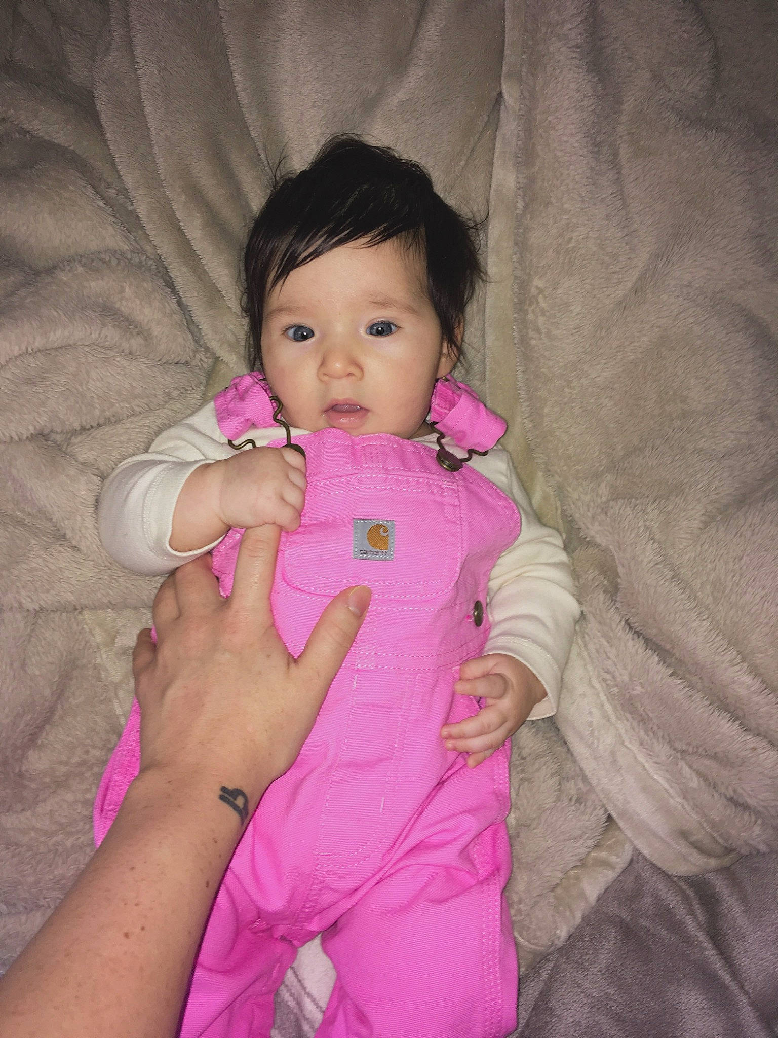 Sienna is registered to the contest to win money with this photo: baby, baby_toddler_clothing, cheek, comfort, eyebrow, eyelash, finger, gesture, happy, head, iris, lip, magenta, nose, person, pink, skin, sleeve, textile, thumb